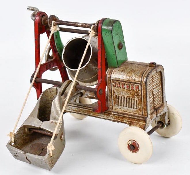 Kenton Cast Iron Jaeger Cement Mixer: Kenton cast iron Jaeger cement mixer. The wheels and string have been replaced. The cranks for the drum and chute work. Good condition with paint loss and wear from play and age. Measures approximatel