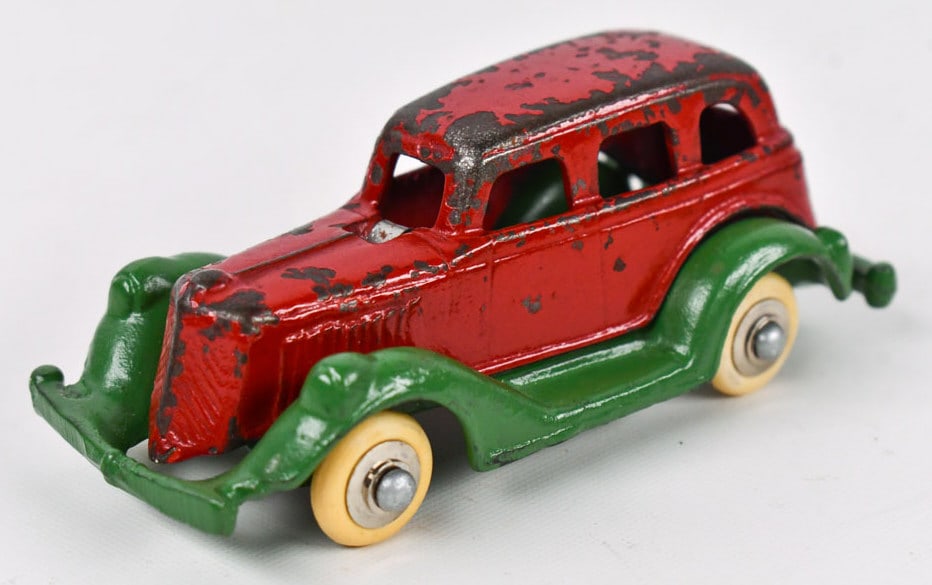 AC Williams Cast Iron Take A Part Sedan Car: AC Williams cast iron take a part sedan car. The car has newer wheels. Displays well painted in red with green fenders. The car has paint loss and wear from play and age. Measures approximately 4-3/4"