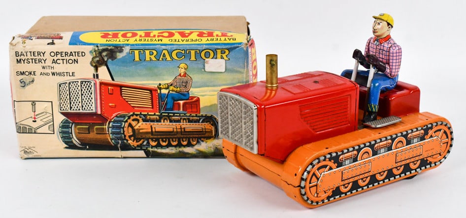 Japan Battery Op. Mystery Action Tractor w/ Box: Japan tin litho battery operated myster action tractor / crawler with smoke and whistle. The tractor is in good condition with some scratches and wear from play / age. It is untested. The box has crus