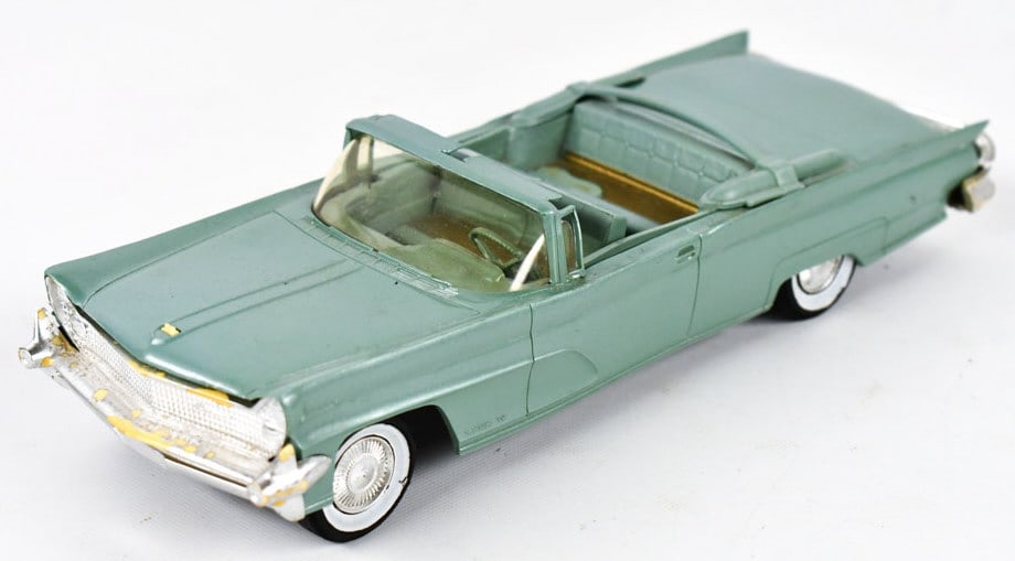 AMT 1959 Lincoln Mark IV Convertible Promo Car: AMT 1959 Lincoln Continental Mark IV convertible dealer promo car. The car has warping, discoloration, and wear from age. The hood ornament is damaged. Measures approximatley 8-3/4" long.