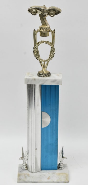 1960s Racing Trophy: The Sports Car trophy has a two-seater roadster topper. The Marble base with two eagles anchors the trophy. The plating is coming off of the topper. Measures approximately 20" tall.REF#RWS3003