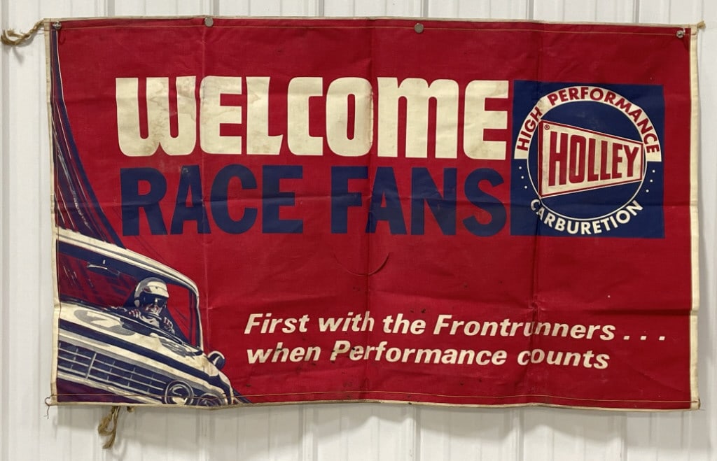 Vintage Holley Carburetors Auto Race Banner: Vintage holley Carburetors " Welcome Race Fans" canvas advertising banner. Appears to be in overall good condition with discoloration, staining, and wear from use and age. It measures approximately 56
