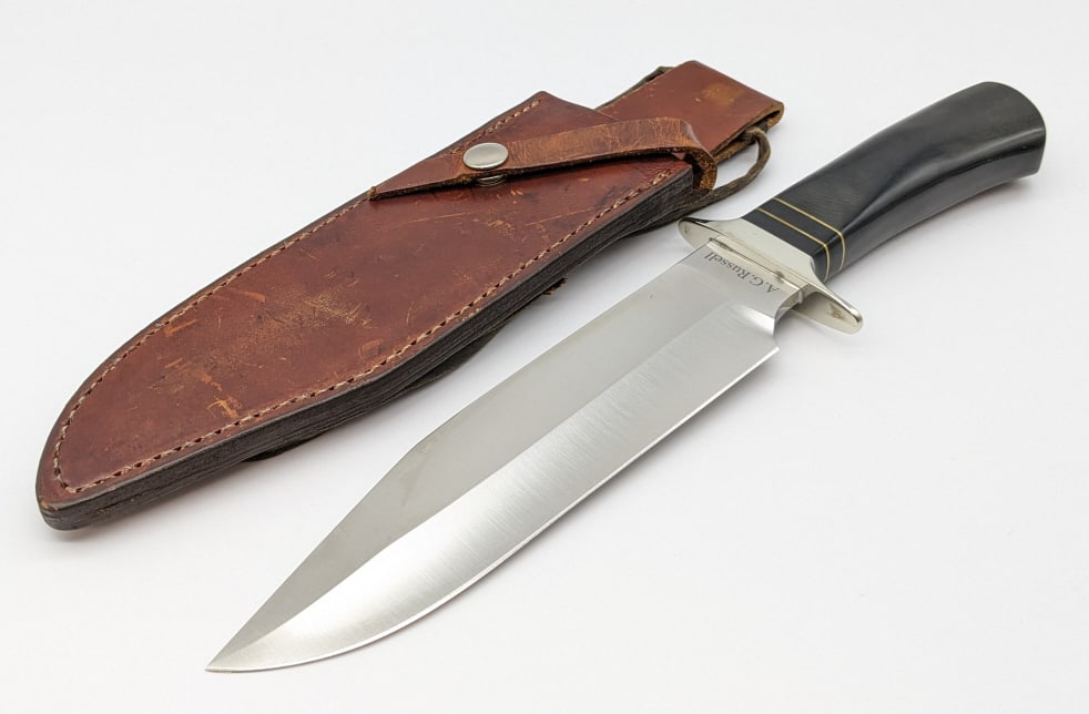 A.G. Russell 2003 1861 Pattern Big Bowie Knife: A.G. Russell 2003 1861 Pattern Big Bowie Knife w/ Sheath. Features a fullered blade, double downturned nickel guard, and black micarta handle with brass spacers. Knife is in like new condition. Blade 