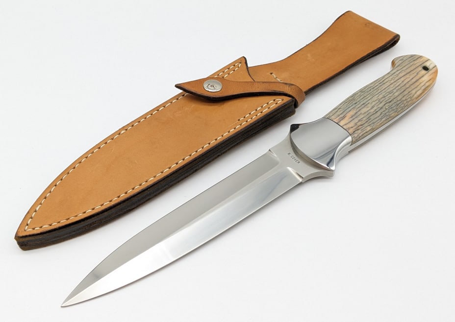 Ray Cover Custom Giraffe Bone Fighting Dagger: Ray Cover Custom Giraffe Bone Fighting Dagger w/ Sheath. Features a double endged blade, double reduced hilt, full tang design, and exotic giraffe bone handle with wrist thong hole. The sheath is sign