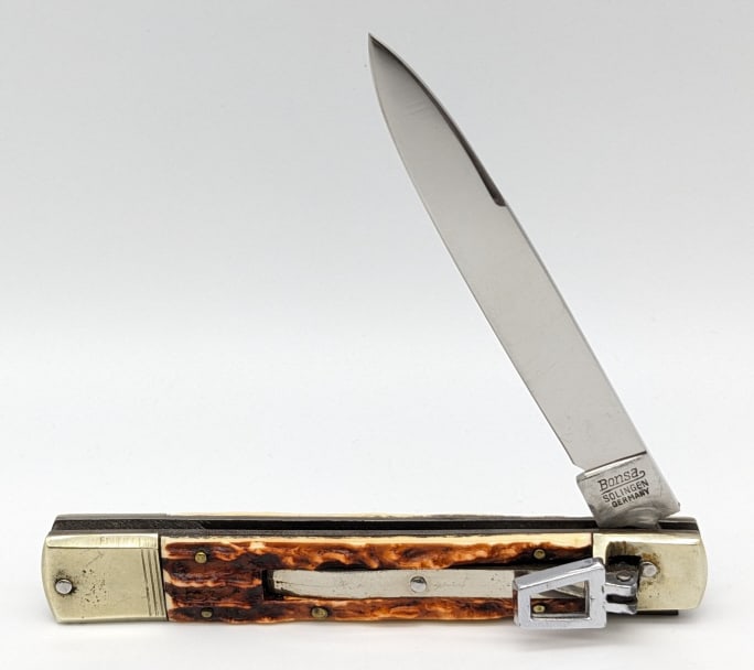 Bonsa Faux Stag Leverlock Switchblade Knife: Bonsa Faux Stag Leverlock Switchblade Knife. Knife is in nice condition with a polished blade, brass tone bolsters with some dings, and faux stag delrin handle scales. Blade spring is strong and locks