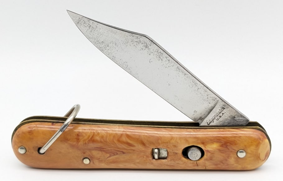 Edgemaster Orange Marbled Paratrooper Switchblade: Edgemaster Orange Marbled Paratrooper Switchblade Knife. Knife is in very nice condition with a polished blade and light finish wear. Blade spring is strong and has very little play when open. Measure