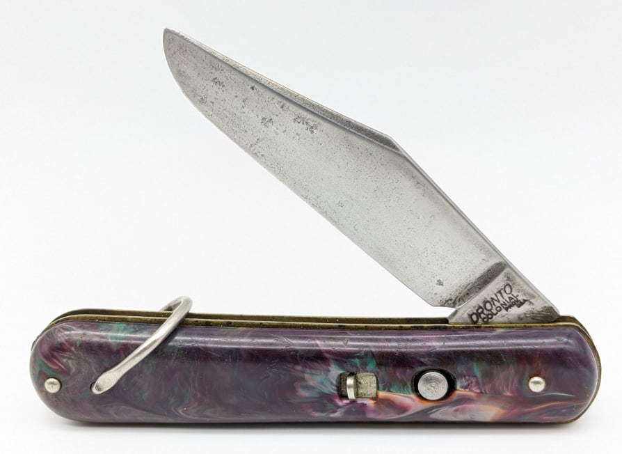 Pronto Colonial Purple Marbled Paratrooper Knife: Pronto Colonial Purple Marbled Paratrooper Switchblade Knife. Knife is in nice condition with wear on the blade from use and some light carbon spotting. Blade spring is strong and has some play when o