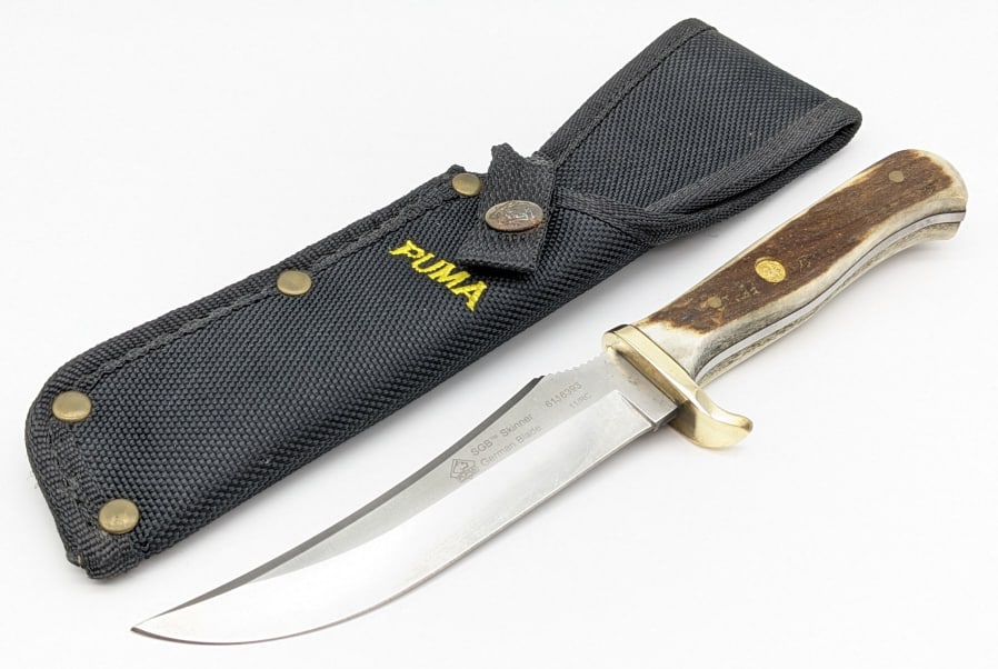 Puma Model SGB Skinner 6116393 w/ Sheath: Puma Model SGB Skinner 6116393 w/ Sheath. Features a trailing point blade with thumb notches, single brass downturned guard, and stag handle scales. Knife is in very nice condition with some light wea