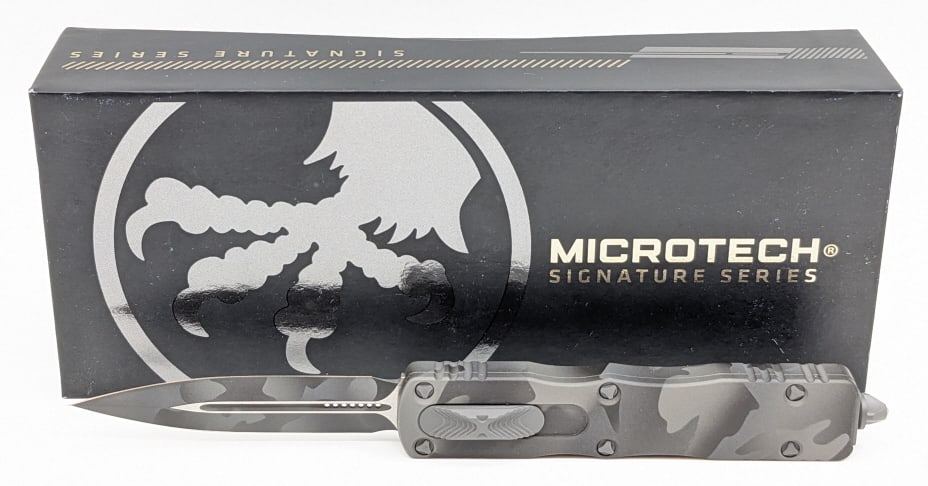 NIB Microtech Signature Series Dirac D/E OTF: NIB Microtech Signature Series Dirac D/E Urban Camo OTF Knife. Knife is in new condition. Overall length of 4-3/8in when closed.