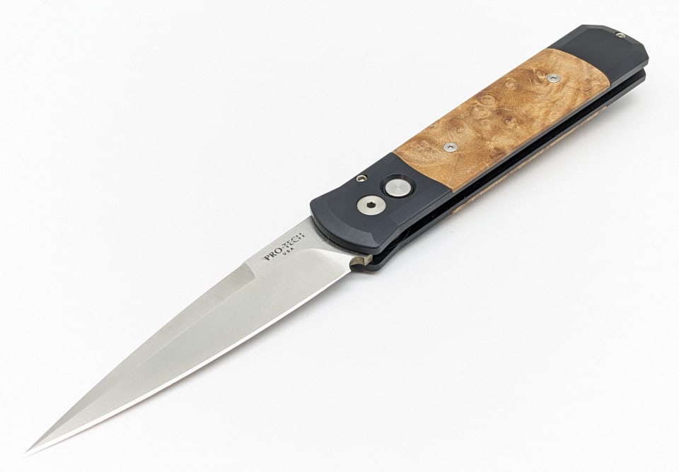 Protech Godfather Automatic Knife: Protech Godfather Automatic Knife. Features a single edge spear point blade, and black aluminum and curley maple wood handle. Knife is in new condition. Overall length of 5-3/8in when closed.