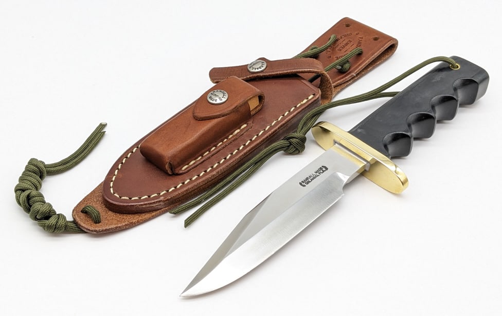Randall Model 15 Airman Knife w/ Randall Sheath: Randall Model 15 Airman Knife w/ Randall Sheath. Features a brass oblong hilt, black micarta handle with finger grooves, full tang design, and wrist thong hole. Knife is in near new condition with min