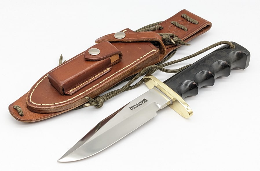 Randall Model 15 Airman Knife w/ Randall Sheath: Randall Model 15 Airman Knife w/ Randall Sheath. Features an oblong brass double guard, and full tang design black micarta finger groove handle with wrist thong hole. Knife is in very nice condition w