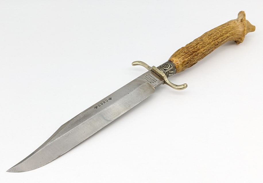 Antique EBRO Alfred Williams Sheffield Eng Knife: Antique EBRO Alfred Williams Sheffield England Knife. Features a clip point blade stamped woth branding, serpentine aluminum double guard, decorated silver plate collar, and crown stag handle with a c