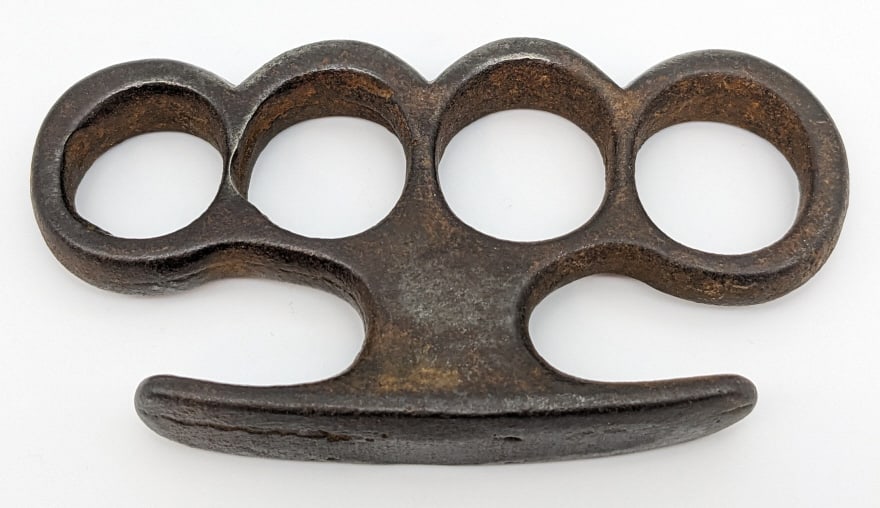 Vintage Brass Knuckle Dusters: Vintage Brass Knuckle Dusters. Knuckles are in nice condition with some wear from age, casting pits, and one thin spot. Measures 4-1/8in across. Please check your local laws before bidding. We will no