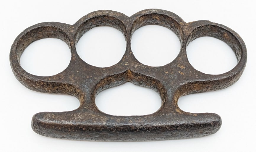 Vintage Brass Knuckle Dusters: Vintage Brass Knuckle Dusters. Knuckles are in nice condition with some wear from age, casting pits, and some corrosion. Measures 4-1/8in across. Please check your local laws before bidding. We will n