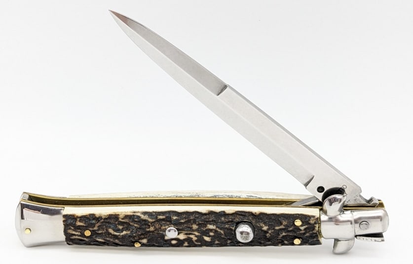 Italian Faux Stag Kriss Stiletto Switchblade: Italian Faux Stag Kriss Stiletto Switchblade. Knife is in very nice condition with a polished blade, polished bolsters, faux stag handle scales, and swing guard locking design. Blade spring is strong
