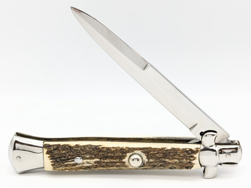 Large Rostfrei Italian Stag Stiletto Switchblade: Large Rostfrei Italian Stag Stiletto Switchblade. Knife is in very nice condition with a polished blade, polished bolsters, stag handle scales, and swing guard locking design. Blade spring is strong a