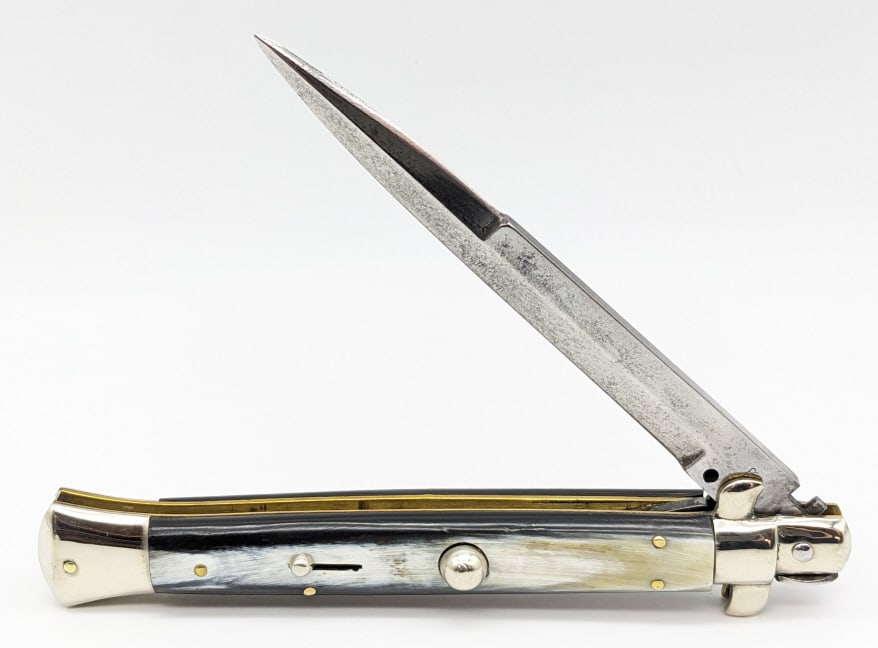 Inter Italian Horn Handle Stiletto Switchblade: Inter Italian Horn Handle Stiletto Switchblade Knife. Knife is in nice aged condition with carbon spotting and light pitting on the blade and sharpening marks, light scuffs on the bolsters from handli