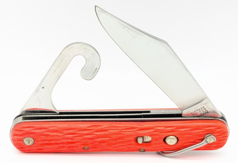 Schrade Walden MC1 Orange Paratrooper Switchblade: Schrade Walden MC1 Orange Paratrooper Switchblade. Knife is in very nice condition with minimal wear, and orange plastic handle scales. Blade spring is strong, and locks tight when open. Overall measu