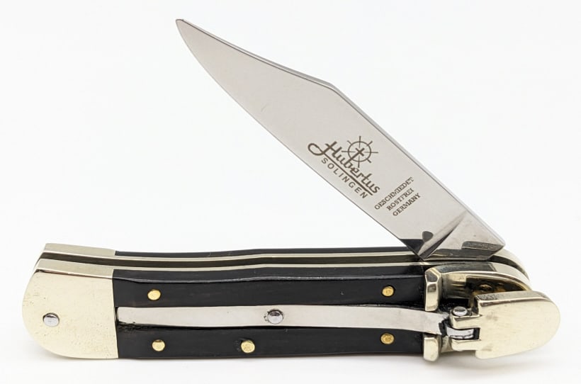 Hubertus Solingen Leverlock Switchblade Knife: Hubertus Solingen Leverlock Switchblade Knife. Knife is in very nice condition with a polished blade, polished bolsters, and ebony wood handle scales. Blade spring is strong and locks tight when open.