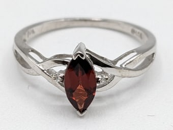 Ladies 10K White Gold Garnet Cocktail Ring: Ladies 10K white gold garnet & white sapphire cocktail ring. The ring is size 7 and the total weight is approx. 1.43 grams.