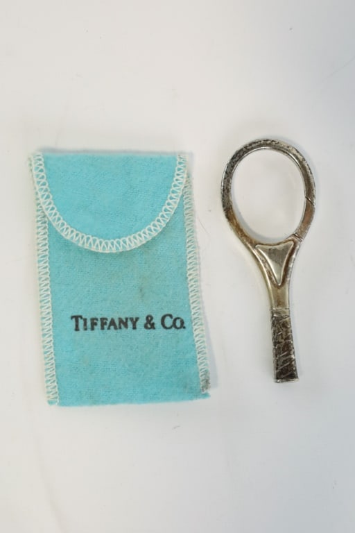 Tiffany & Co. Sterling Tennis Racquet Key Ring: Tiffany & Co sterling silver tennis racquet key ring. The key ring measures approximately 3" tall x 1-1/8" across. Nice condition in the original Tiffany pouch. Weighs 25 grams.