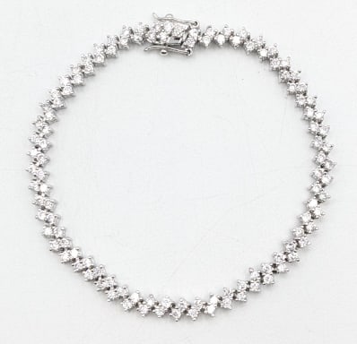 Ladies Sterling White Sapphire Tennis Bracelet: Ladies sterling silver synthetic white sapphire tennis bracelet. The bracelet measure 7.75" long and the total weight is approx. 13.56 grams.