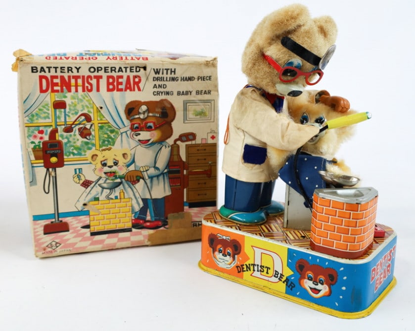 Vintage Japan Battery Operated Denist Bear In Box: Vintage S&E Japan battery operated tin litho Denist Bear toy. The toy features a drilling hand-piece and crying baby bear. It is in nice used condition in the original box, missing the baby bear cup.