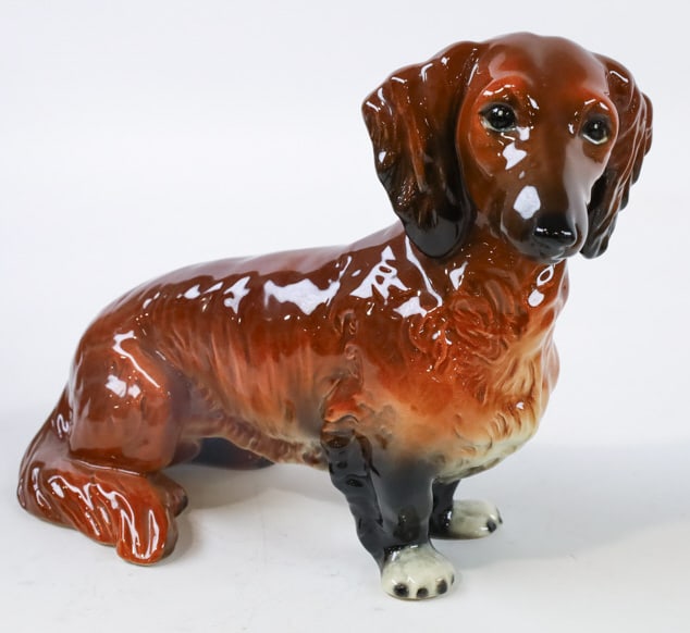 Large Goebel Porcelain Dachshund Figurine: Large vintage Goebel West Germany porcelain figurine featuring a sitting Dachshund. Great quality and detail. Marked on the base. Measures approximately 8" tall x 11-1/2" across x 5" deep.