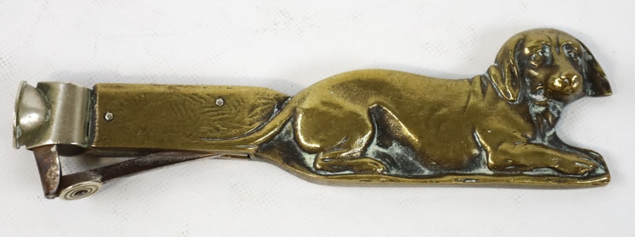 Antique Brass Dachshund Cigar Cutter: Antique brass cigar cutter featuring a lying down Dachshund. Great quality and detail, has a stainless "V" cutter. Measures approximately 5-3/4" long. Nice condition.