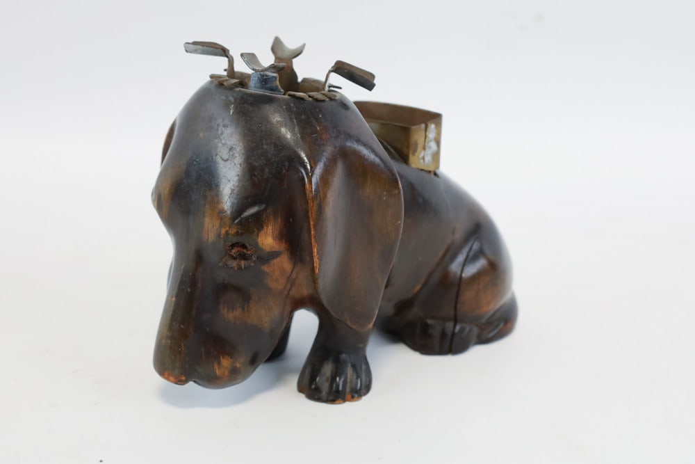 Carved Wood Dachshund Ashtray & Match Holder: Vintage carved wood Dachshund ashtray and match holder. Measures approximately 4-1/2" tall x 6-1/4" across x 3" deep. Good condition with some small chips on the paws and a split in the wood.