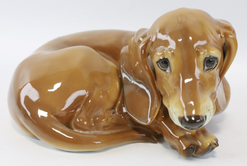 Allach Porcelain WWII German Dachshund Figurine: Very rare WWII Germany Allach painted porcelain figurine featuring a lying down Dachshund. Allach was the porcelain maker of Nazi Germany. Has the SS mark over Allach on the bottom. Great quality and