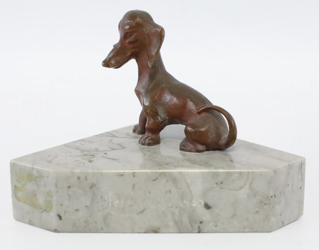 Heidelberg 1945 Bronze Dachshund Paperweight: WWII Heidelberg 1945 bronze sitting Dachshund marble base paperweight. Nice condition, engraved on the marble. Measures approximately 3" tall x 4-1/4" across x 2-1/2" deep. Great condition.