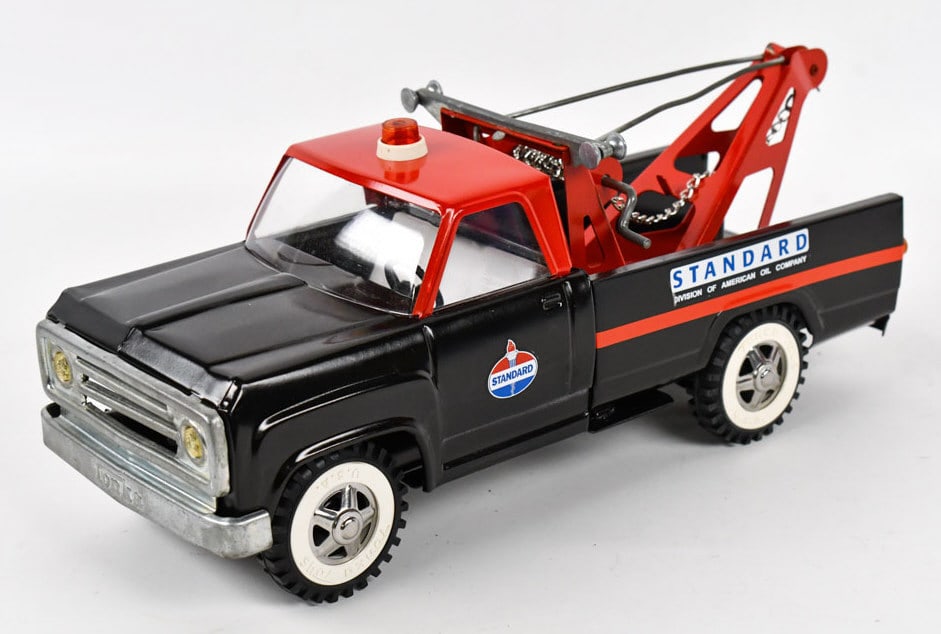 Custom Tonka Standard Oil Wrecker Tow Truck: Custom Tonka Dodge Standard Oil wrecker tow truck. Displays well with Standard oil decals. Good condition with some paint streaking, but still displays well. Measures approximately 14" long.