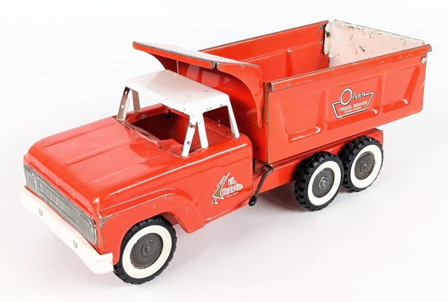 Li'l Beaver Canada Dept Of Highway Dump Truck: Li'l Beaver Canadian dump truck. The truck is missing the windshield and horn on the roof. The truck has paint loss and wear from play and age. The bed is marked Olsen Truck Bodies Tilbury, Ontario an