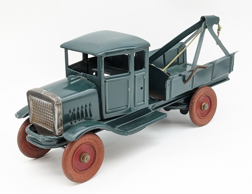 Kingsbury Little Jim Windup Tow Truck: Very hard to find Kingsbury windup tow truck. From a line of "Little Jim" toys exclusively sold at J.C. Penny. The truck has some paint chips on the front fender. The windup mechanism works. Measures 