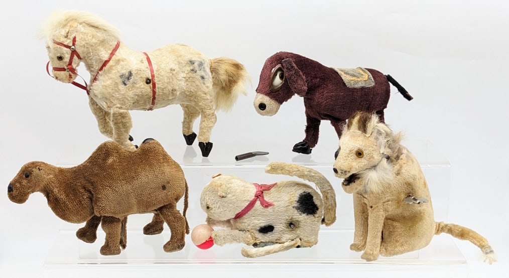 Japan Windup Lion, Camel, Donkey, Horse & Cat: Japan windup lion, camel, donkey, horse, and cat. All of the windups work, but some need help to get going. It only comes with one key. All have some fur loss, staining, and wear from age. The lion an