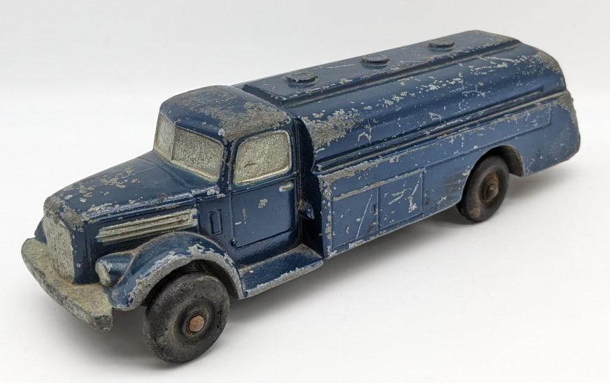 National Products Cast Metal Promo Mack Truck: National Products Cast Metal Promo Mack Tanker Truck. The truck has paint loss, scratches, and wear from play and age. Measures approximately 8" long.