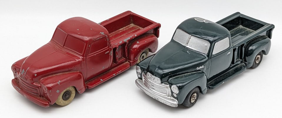 (2) National Products Cast Metal Promo GMC Trucks: (2) National Products Cast Metal Promo GMC Pick Up Trucks. The trucks have been repainted and have paint chips, scratches, and wear from play and age. Measures approximately 8" long.