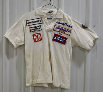 Gurney All American Racers Team Issued Shirt: Early 1970’s IZOD Gurney All American Racers Olsonite Jorgensen Steel Team-Issued Crew Shirt. Size medium. The shirt is in fair used condition with some stains and has sponsor patches on the front,