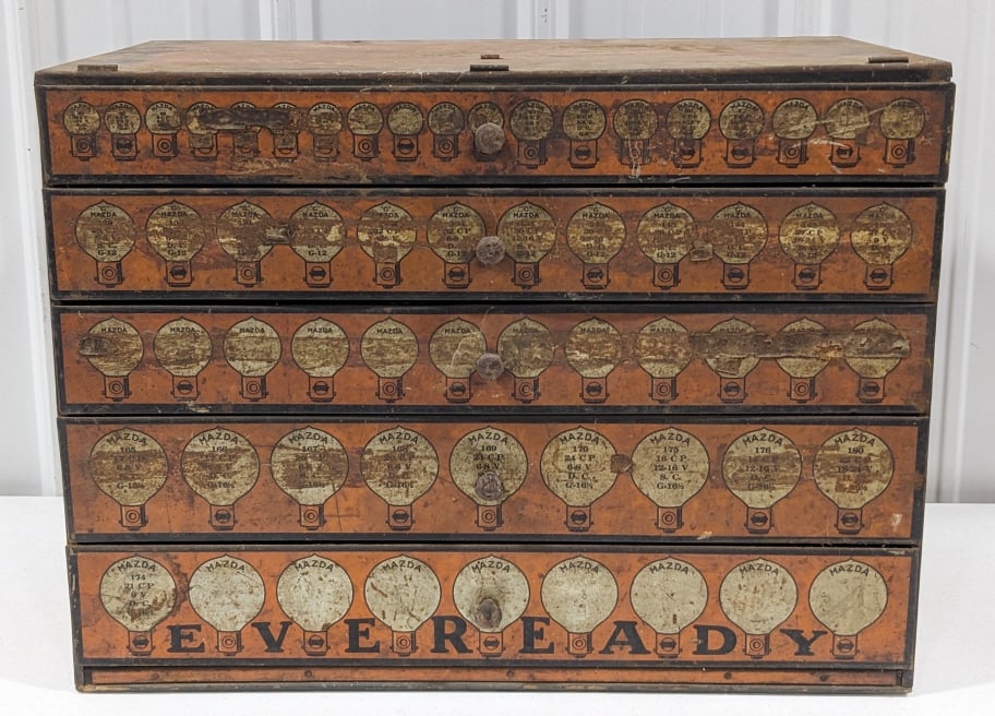 Mazda Eveready Automobile Lamps Display Cabinet: Mazda Eveready automobile lamps 4-drawer display cabinet. The cabinet is in aged condition with paint loss, surface rust, discoloration, and wear from use and age. Some of the drawers still have some 