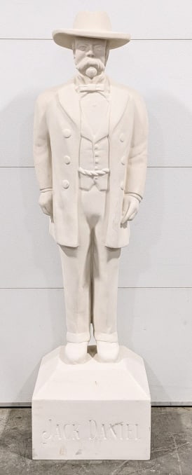 Life Size Fiberglass Jack Daniels Statue: Life Size Fiberglass Jack Daniels Statue. Statue is made of hollow fiberglass with a textrued coating meant to look like concrete. The base that he stands on lists his life years of 1850-1911 and the