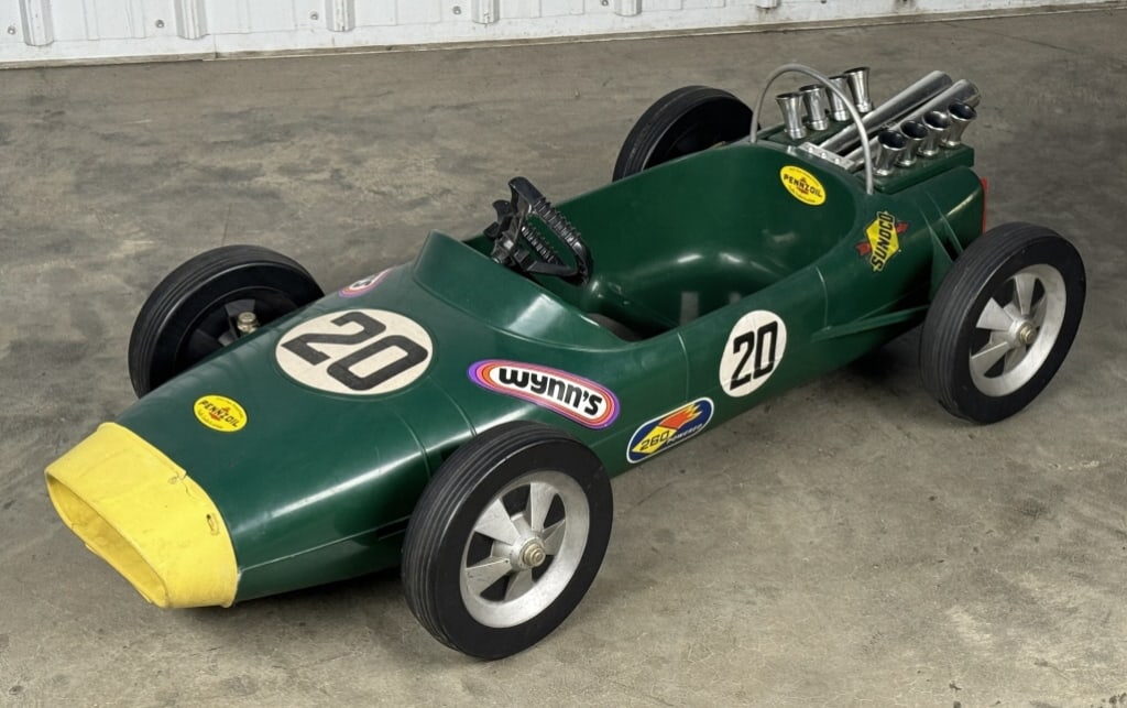 Vintage Lotus Ford Formula 1 Racer Pedal Car: Hard to find vintage Lotus Ford Formula 1 racer plastic pedal car. Appears to be in overall good cosmetic condition with discoloration, and wear from use and age. The front yellow bumper is a thinner