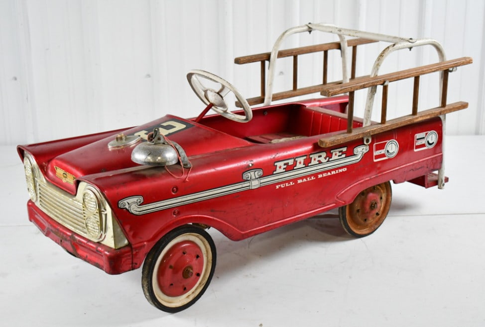 Original Murray Fire Ladder Truck Pedal Car: Original Murray fire ladder truck pedal car. The truck is missing 3 hubcaps, has paint loss, discoloration, and wear from age. Measures approximately 42" long.