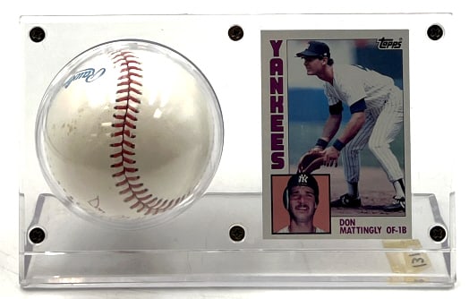 1984 Topps Don Mattingly Rookie & Auto Baseball: 1984 Topps Don Mattingly Rookie & Auto Baseball. The Mattingly rookie is in very nice used condition. The card has been in a hard plastic for protection. The display includes an official American Leag