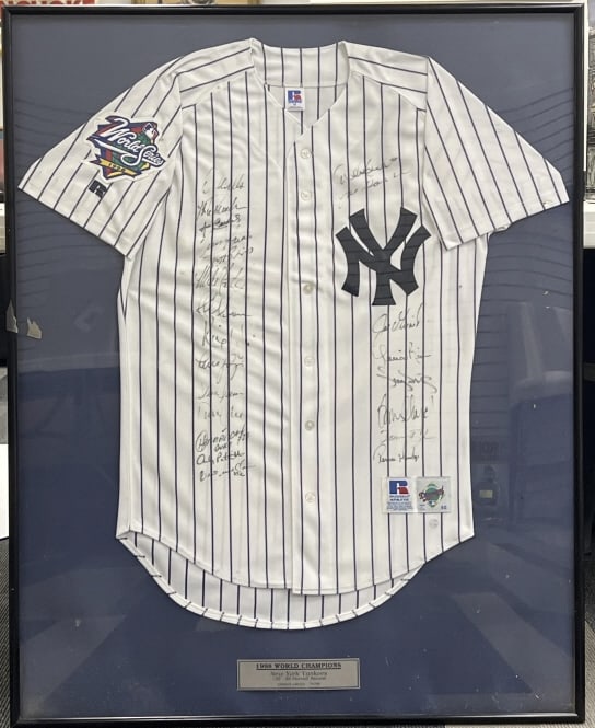 1998 New York Yankees Team Signed Framed Jersey: 1998 New York Yankees Team Signed Framed Jersey. Limited edition New York Yankees jersey is signed by 20 members of the 1998 World Championship team. Jersey is framed. Autographs include Jeter, Raines