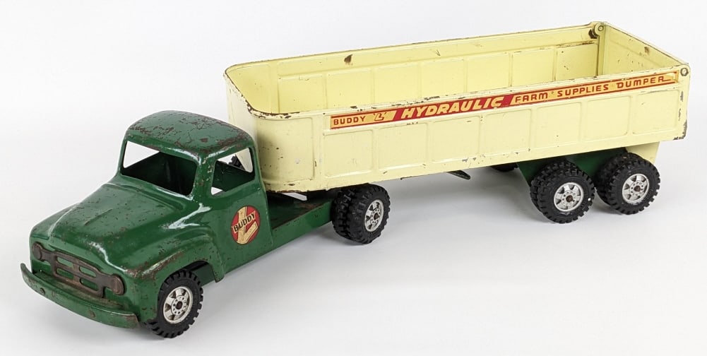 Original Buddy L Farm Supllies Dumper Truck: Original Buddy L Farm Supplies Dumper truck and trailer. The trailer is missing the hydraulic cylinder. The truck and trailer have paint loss, surface rust, and wear from age. Measures approximately 2