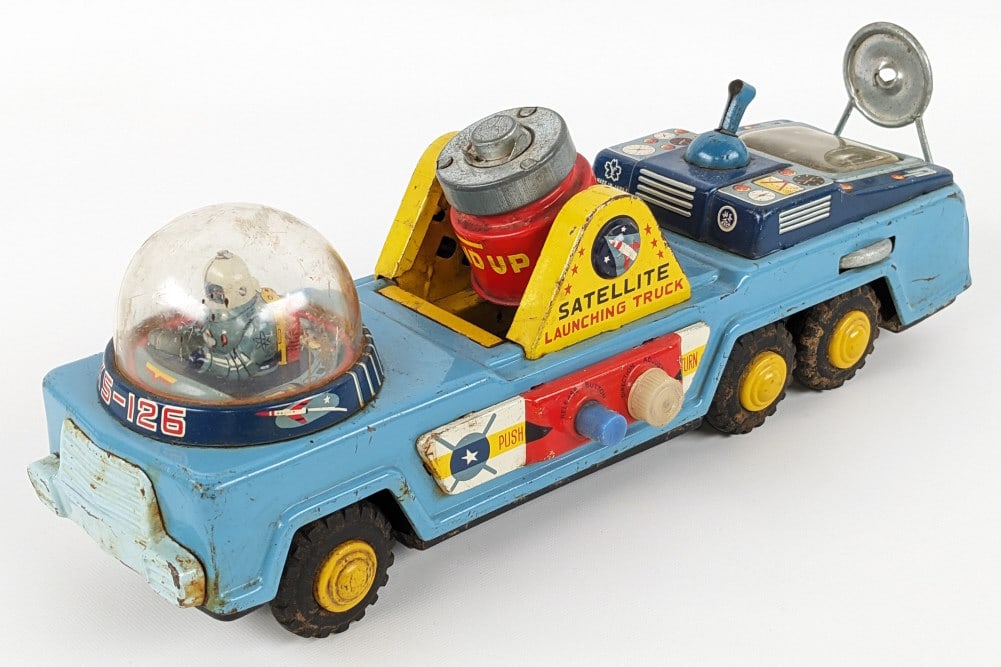 Yonezawa Tin Friction Satellite Launching Truck: Yonezawa tin friction satellite launching truck. The truck is missing the satellite and the metal pole that would carry an extra satellite. The friction works. The dome has some cracks, the truck has 