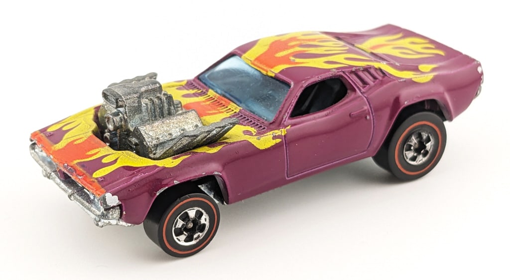Hot Wheels Redline Flying Color Plum Rodger Dodger: Hot Wheels Redline Flying Colors plum Rodger Dodger. The car has some chips around the edges, rub to the roof, and minor wear to the base.