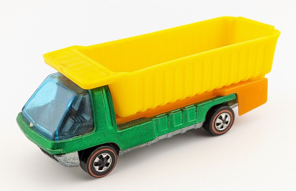 Hot Wheels Redline Green Dump Truck: Hot Wheels Redline green dump truck. The truck has a small touchup on the center of the passenger side, good wheels, and clean base. The plasic dump bed could use a good cleaning.